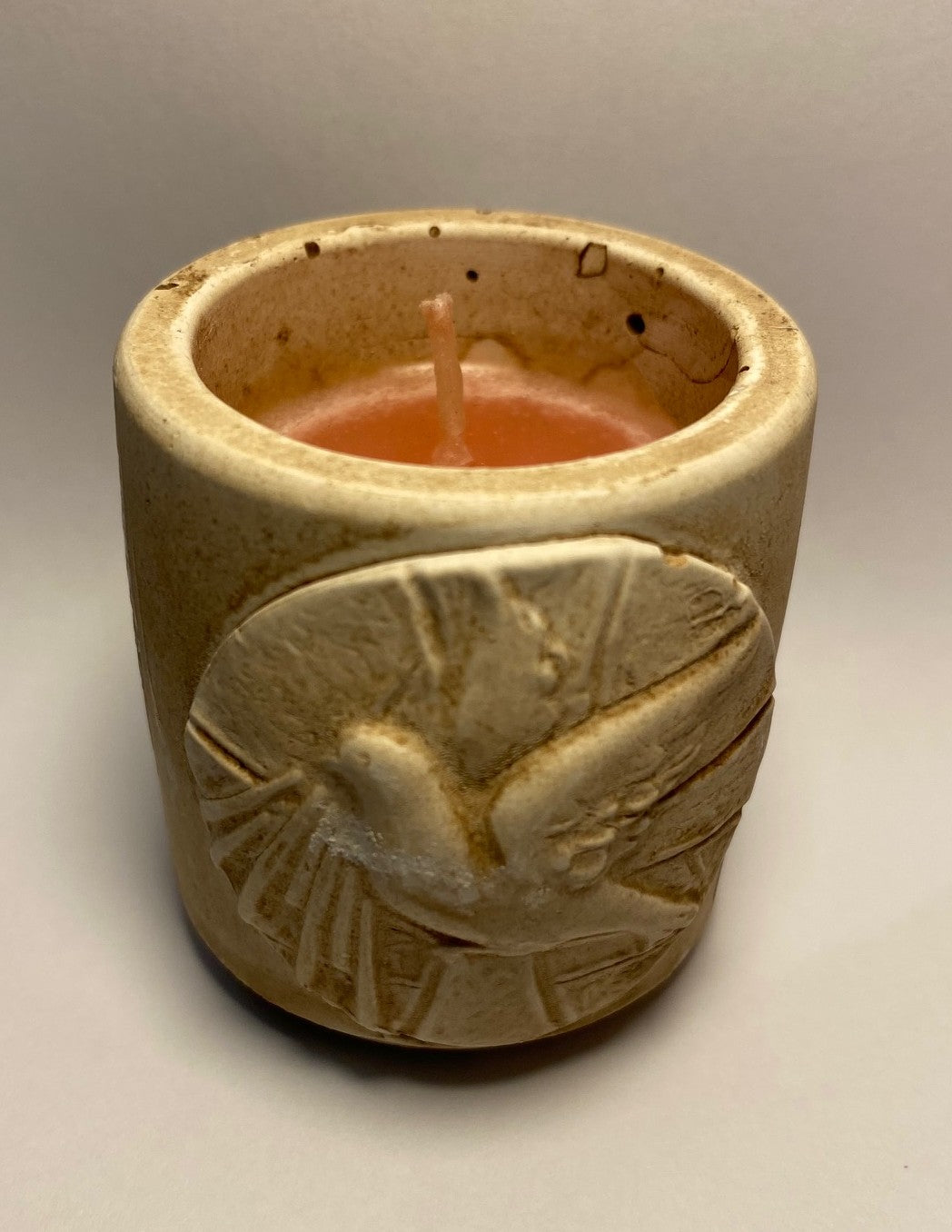 Small earthenware candleholder with holy spirit